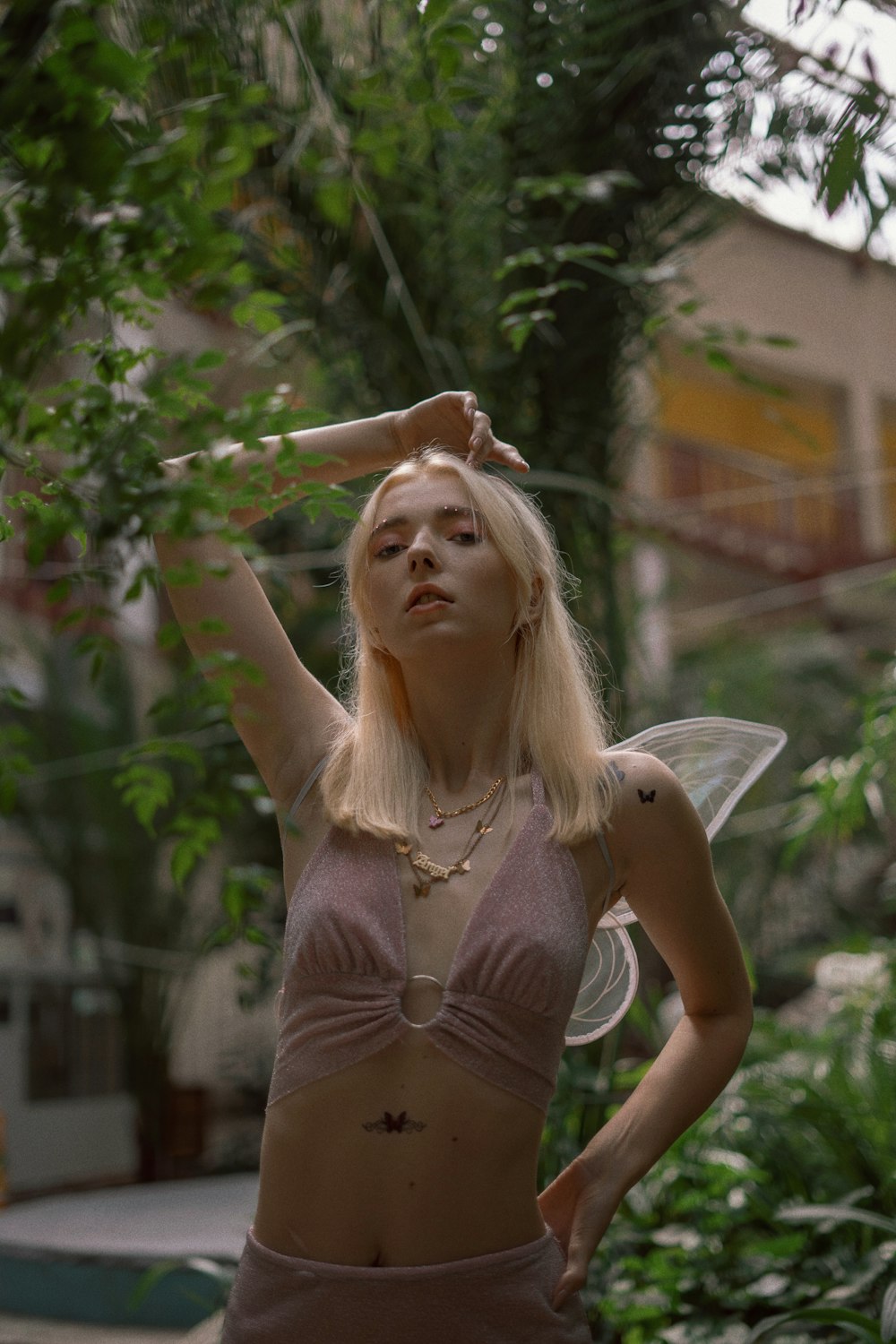 a woman in a pink bikini top and fairy wings