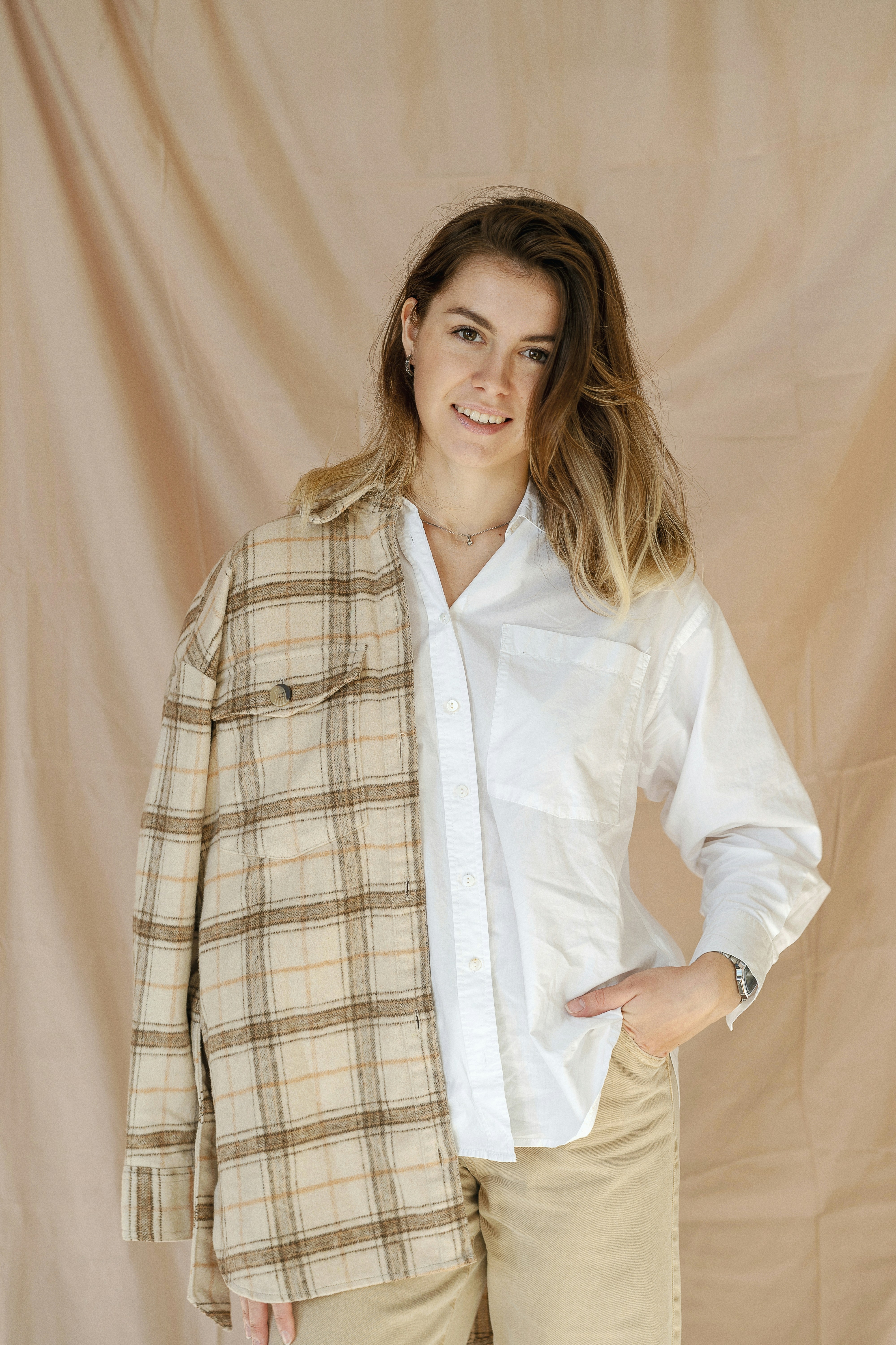 a woman in a white shirt and tan pants