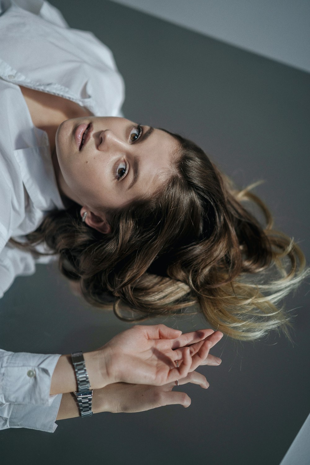 a woman in a white shirt is posing for a picture