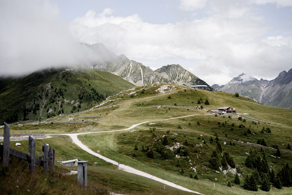 a road winding through a lush green hillside