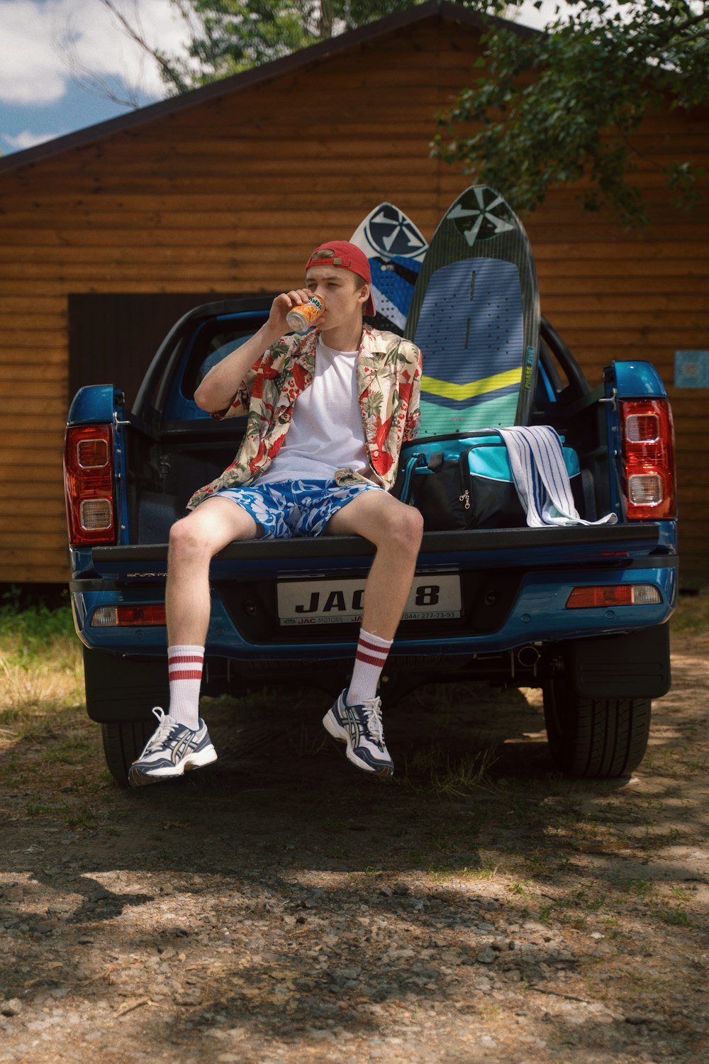 a man sitting in the back of a blue truck