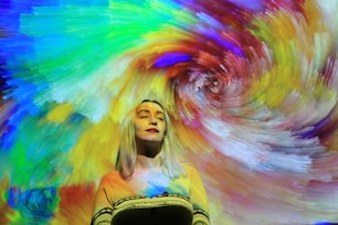 a woman standing in front of a colorful background
