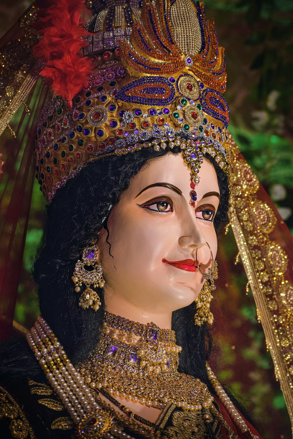 a close up of a statue of a woman wearing a headdress