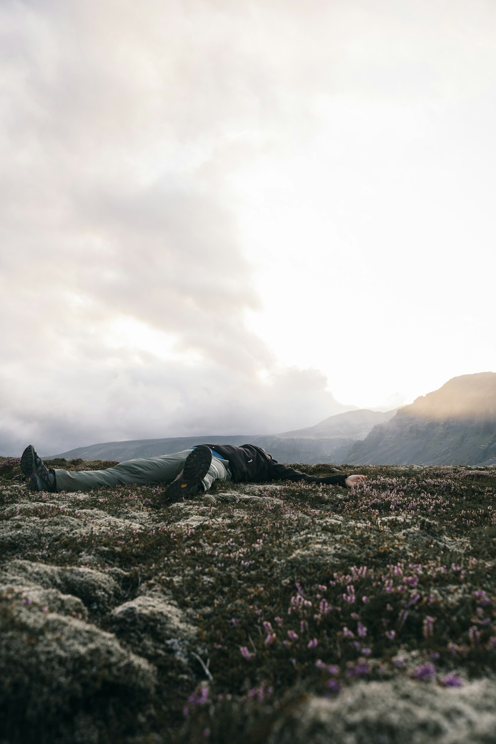 a person laying on the ground in a field