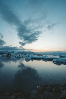a group of icebergs floating on top of a body of water
