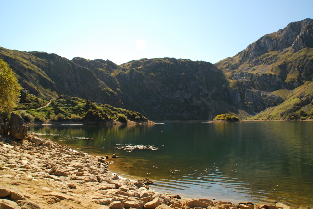 a body of water surrounded by mountains and trees