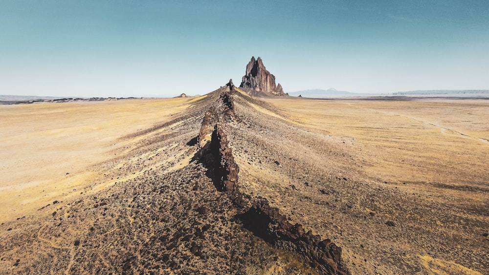 a dirt road in the middle of a desert