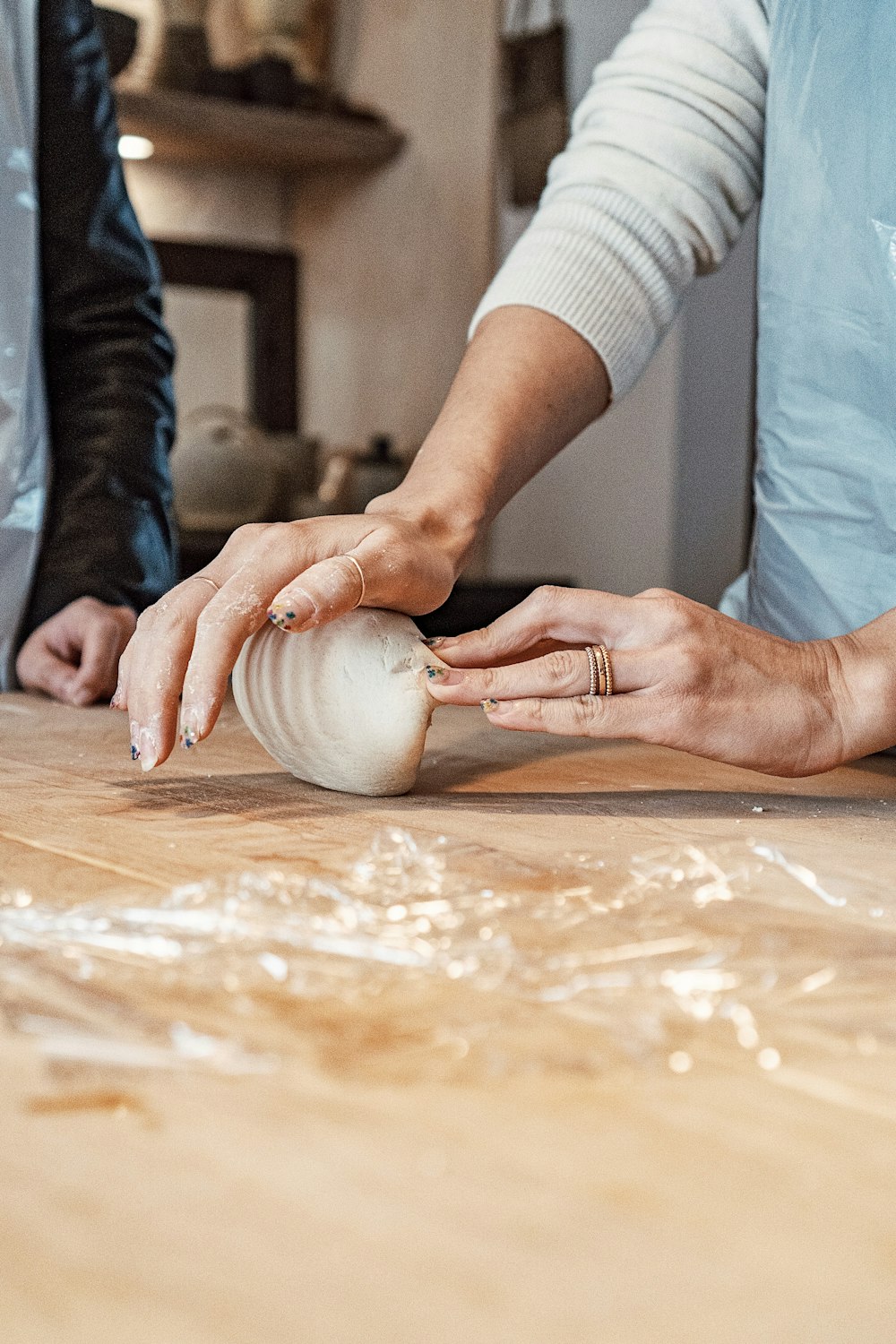 a woman is peeling an onion on a cutting board