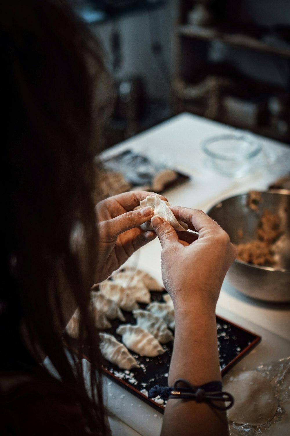 a woman preparing food on a counter top