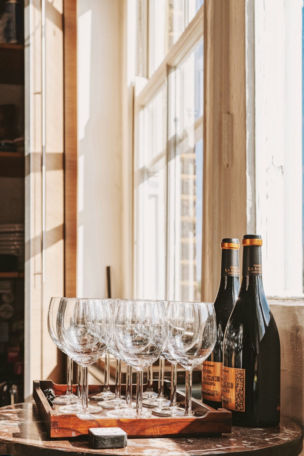 a wooden table topped with wine glasses and bottles