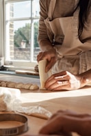 A warm kitchen nook with sunlight streaming over a basket of proofing dough.