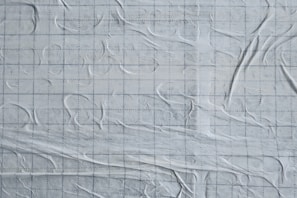 Tactile surface architecture interface showing elements emerging and sinking in a solid material texture