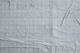 Subtle overlay of faint coordinate plane and equations on a soft neutral gray background.