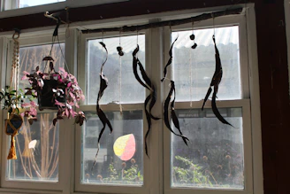 A vibrant suncatcher hanging in a sunny window, casting colorful reflections on a wooden table.
