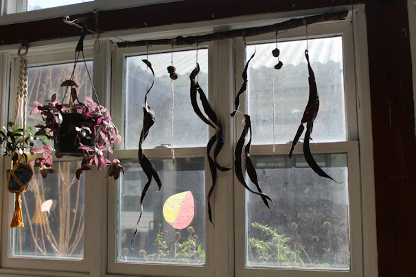 A vibrant suncatcher hanging in a sunny window, casting colorful reflections on a wooden table.