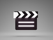 a black and white movie clapper on a gray background