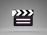 a black and white movie clapper on a gray background