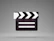 a black and white movie clapper on a gray background