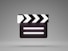 a black and white movie clapper on a gray background