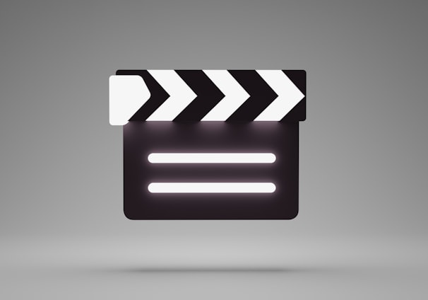 a black and white movie clapper on a gray background