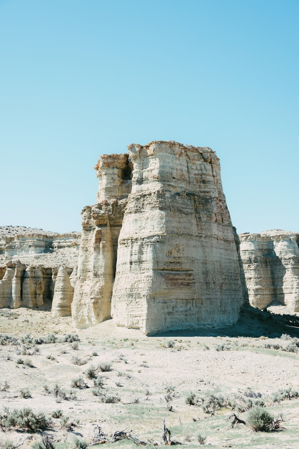 a large rock formation in the middle of a desert