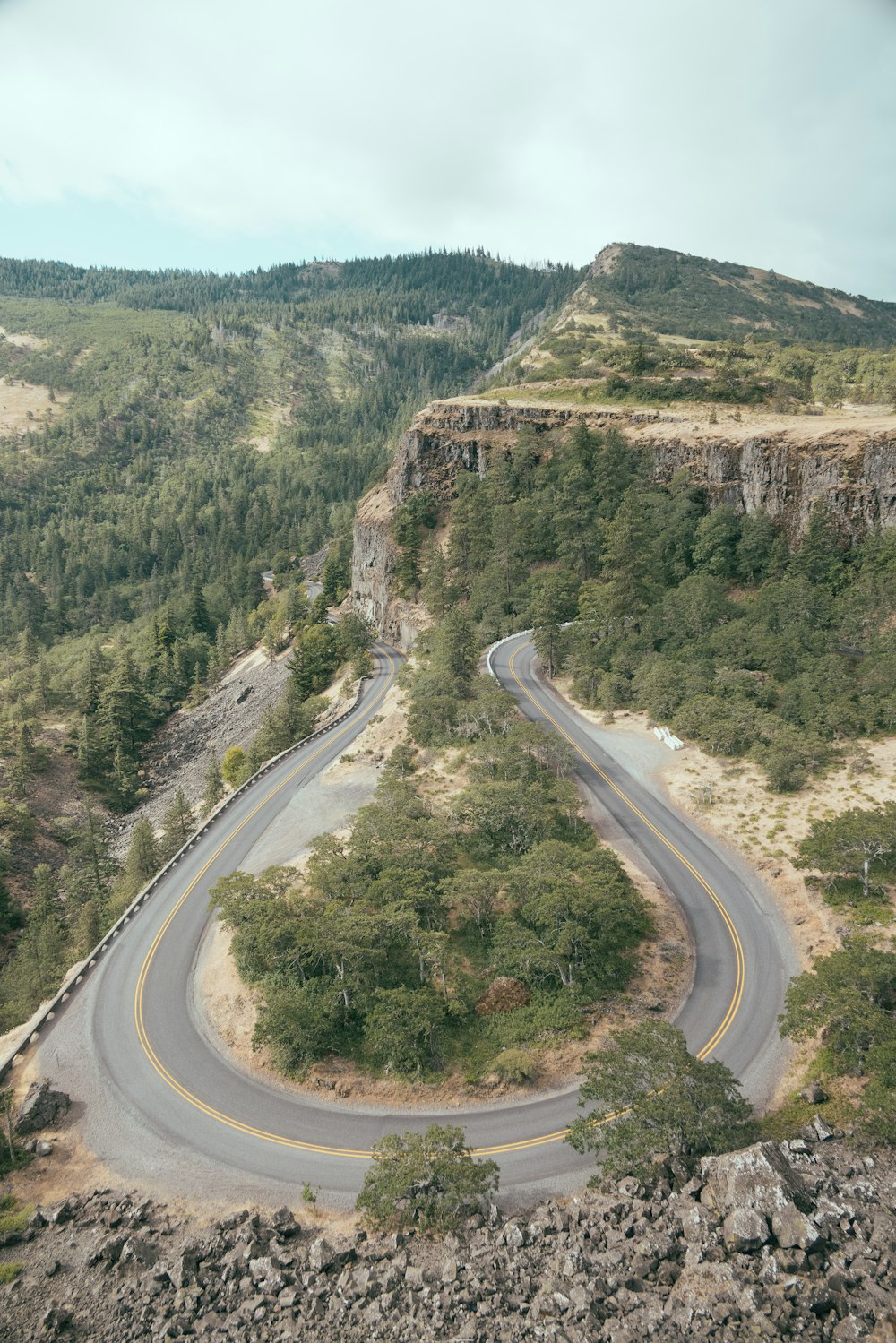 a curve in the road in the middle of a mountain