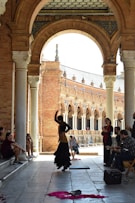 a group of people sitting and standing around a building