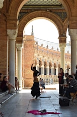 a group of people sitting and standing around a building