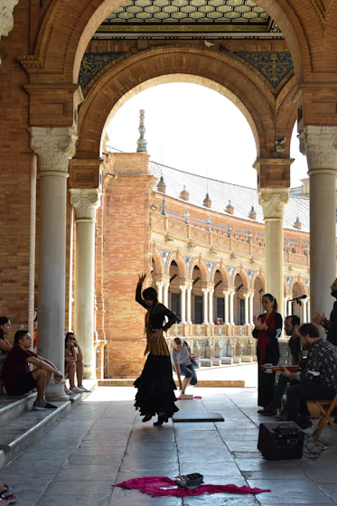 a group of people sitting and standing around a building