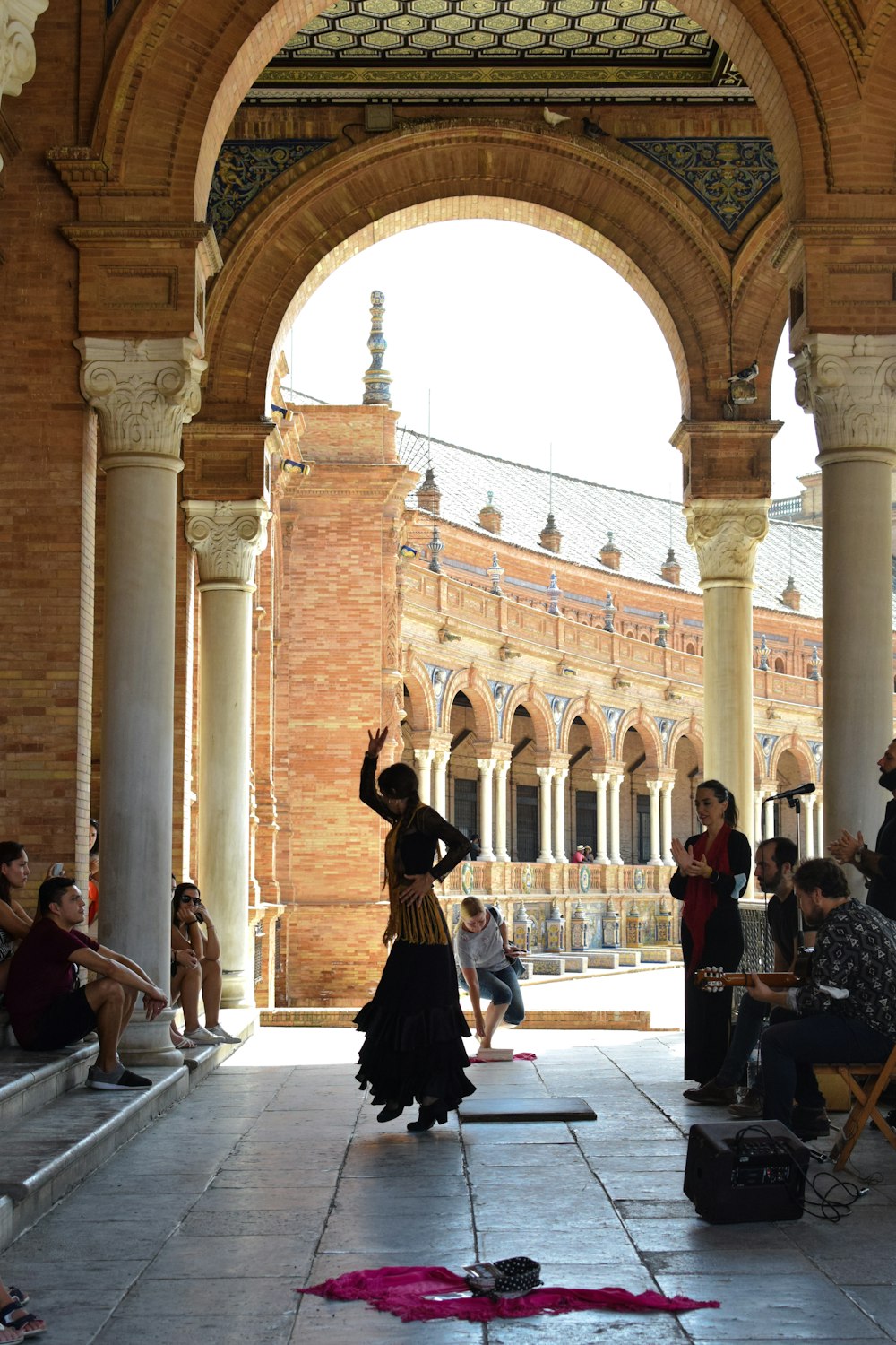 a group of people sitting and standing around a building