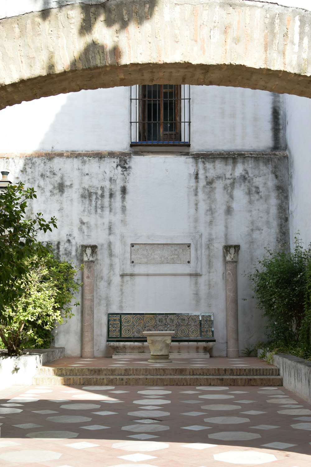 a white building with a bench in front of it