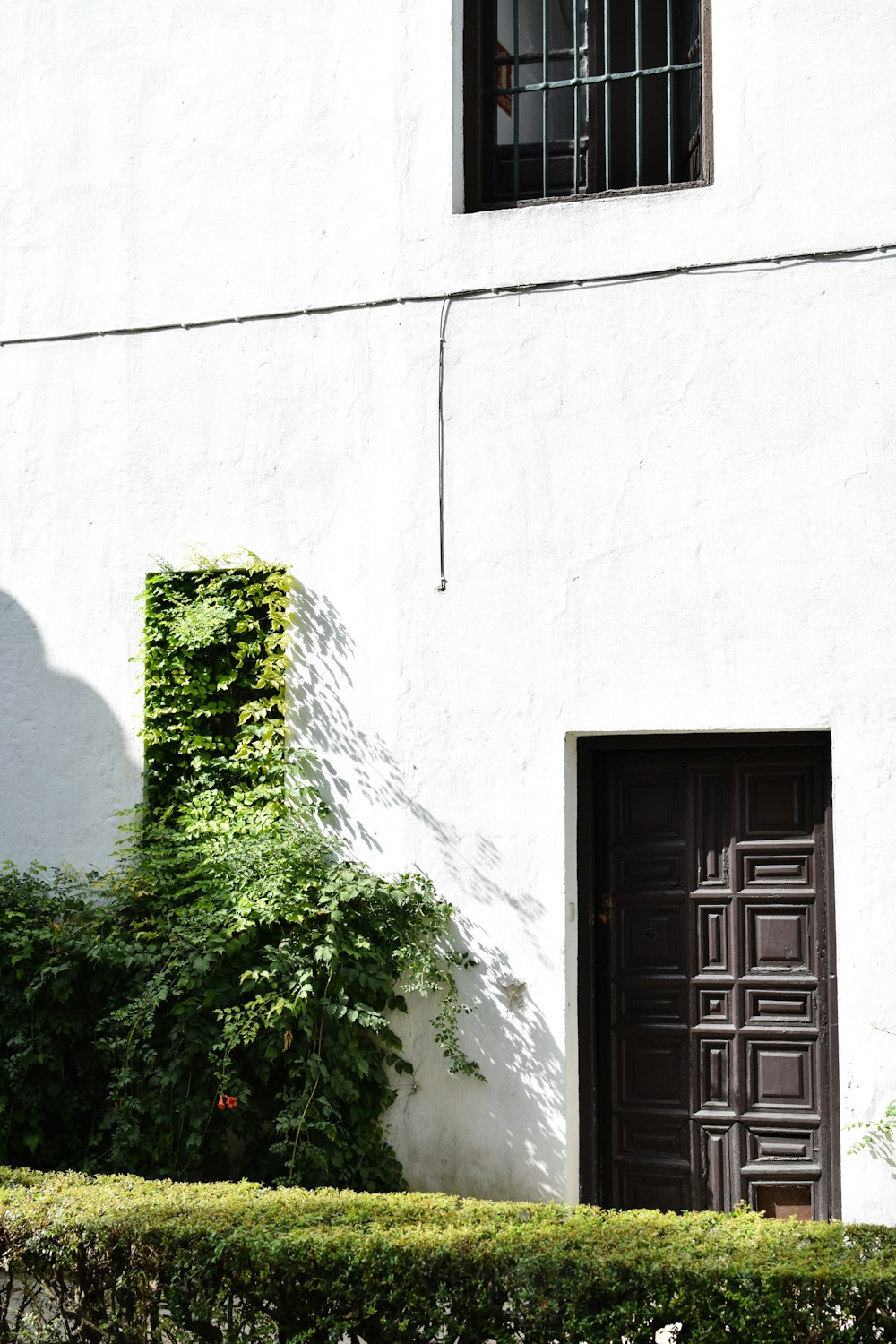 a white building with a brown door and window