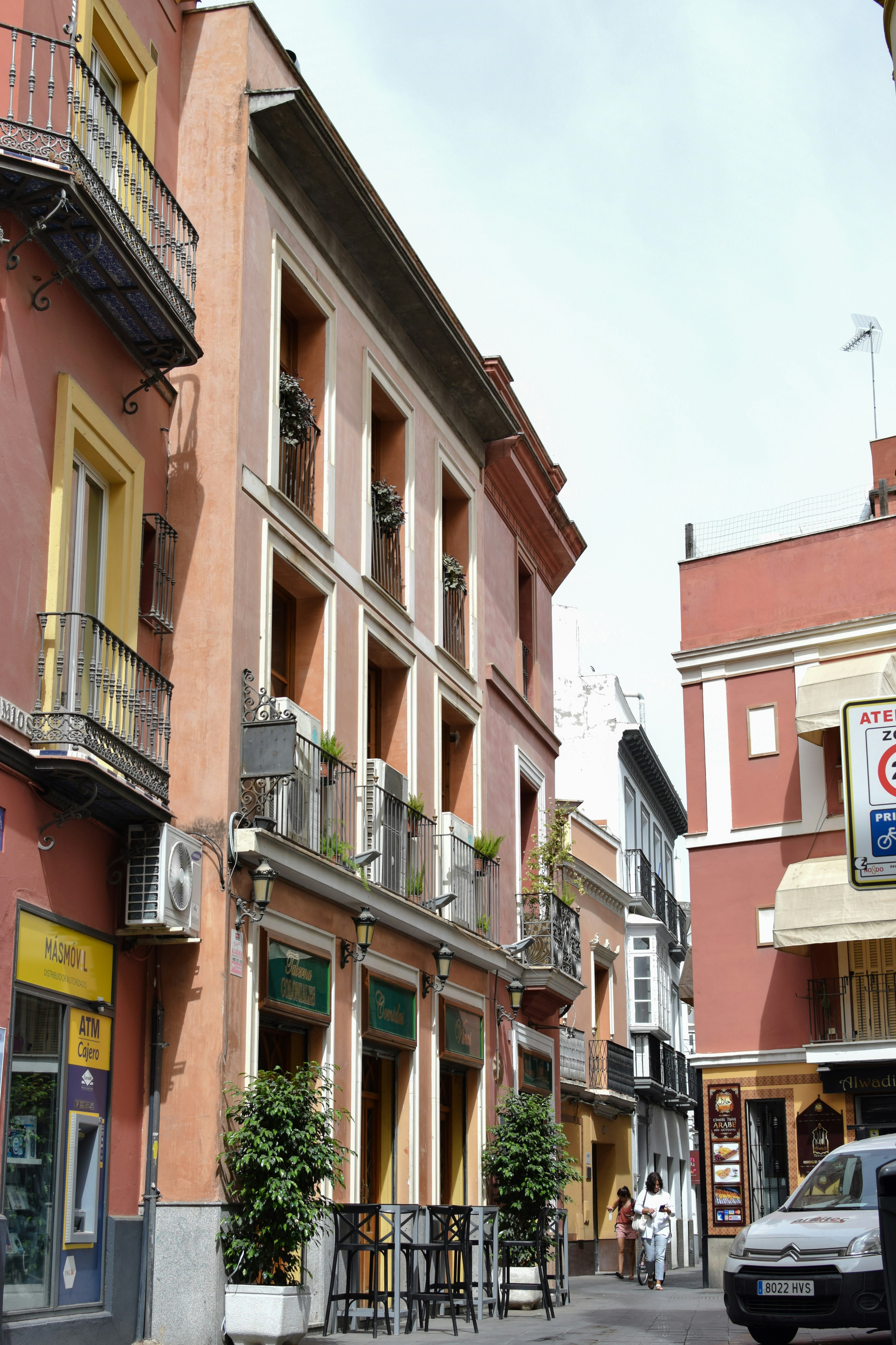 a street scene with a car parked on the side of the road