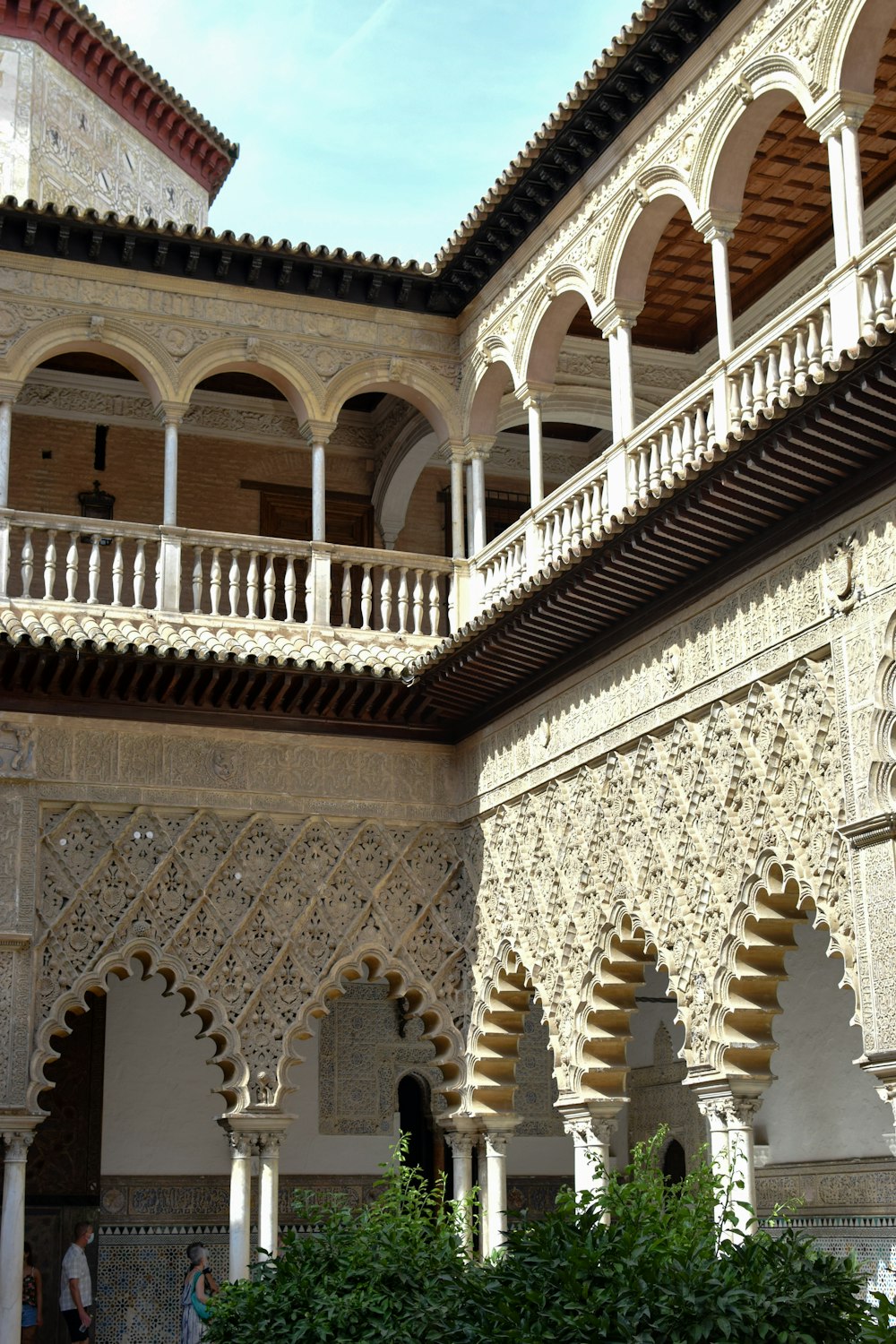 a large building with arches and pillars and a clock on the wall