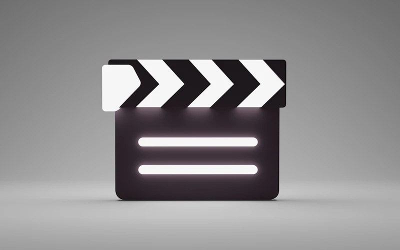 A film clapperboard at rest in low light — the record of years on set, take after take.