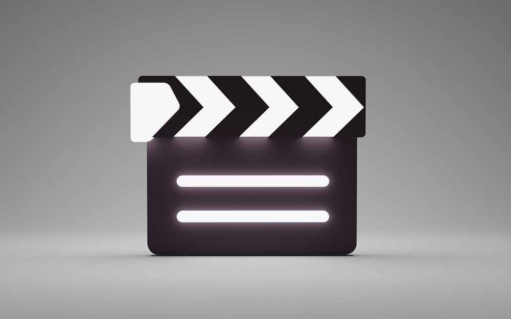 a black and white movie clapper on a gray background