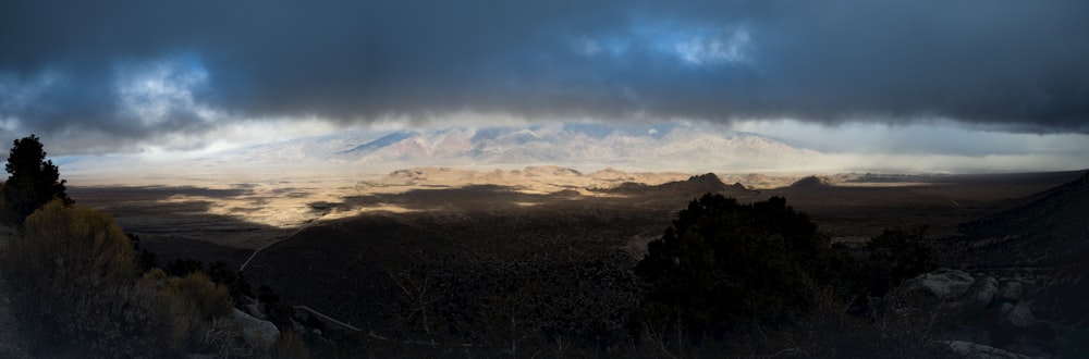 a view of a mountain range under a cloudy sky