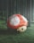 A giant, whimsical mushroom with a large red cap and white spots is nestled in a lush, green forest. The mushroom has eyes reminiscent of an animated character, giving it a playful, surreal quality amidst the tall, dark trees surrounding it.