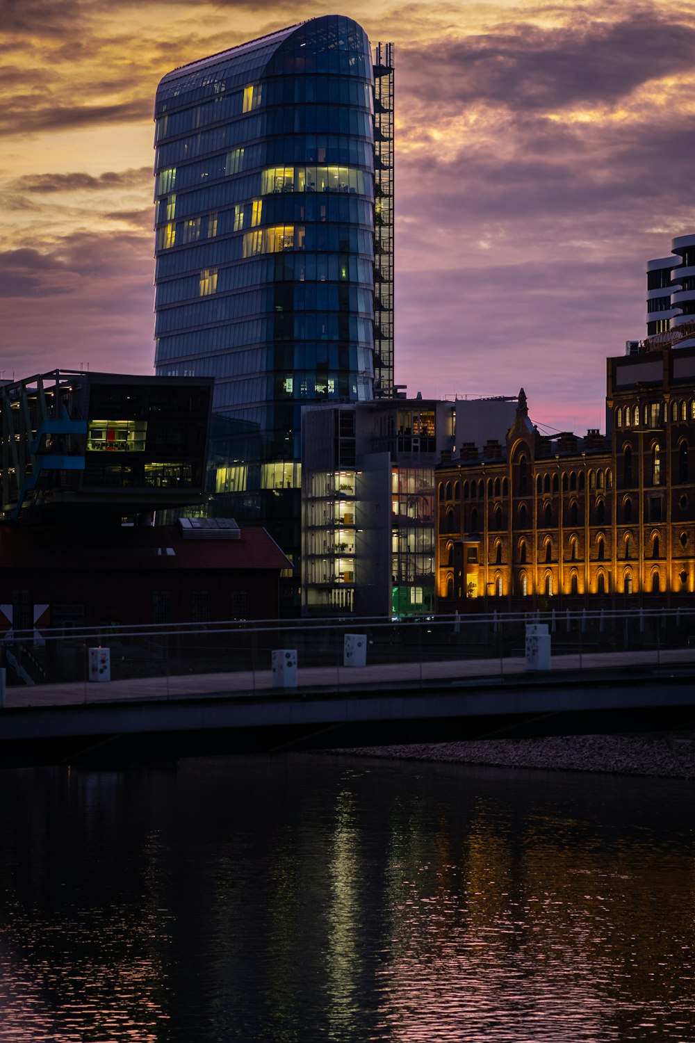 a city skyline at night with a bridge over water