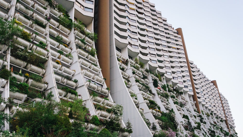 a very tall building with a lot of plants growing on it