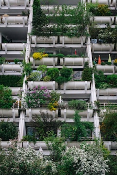 a very tall building with lots of plants growing on it