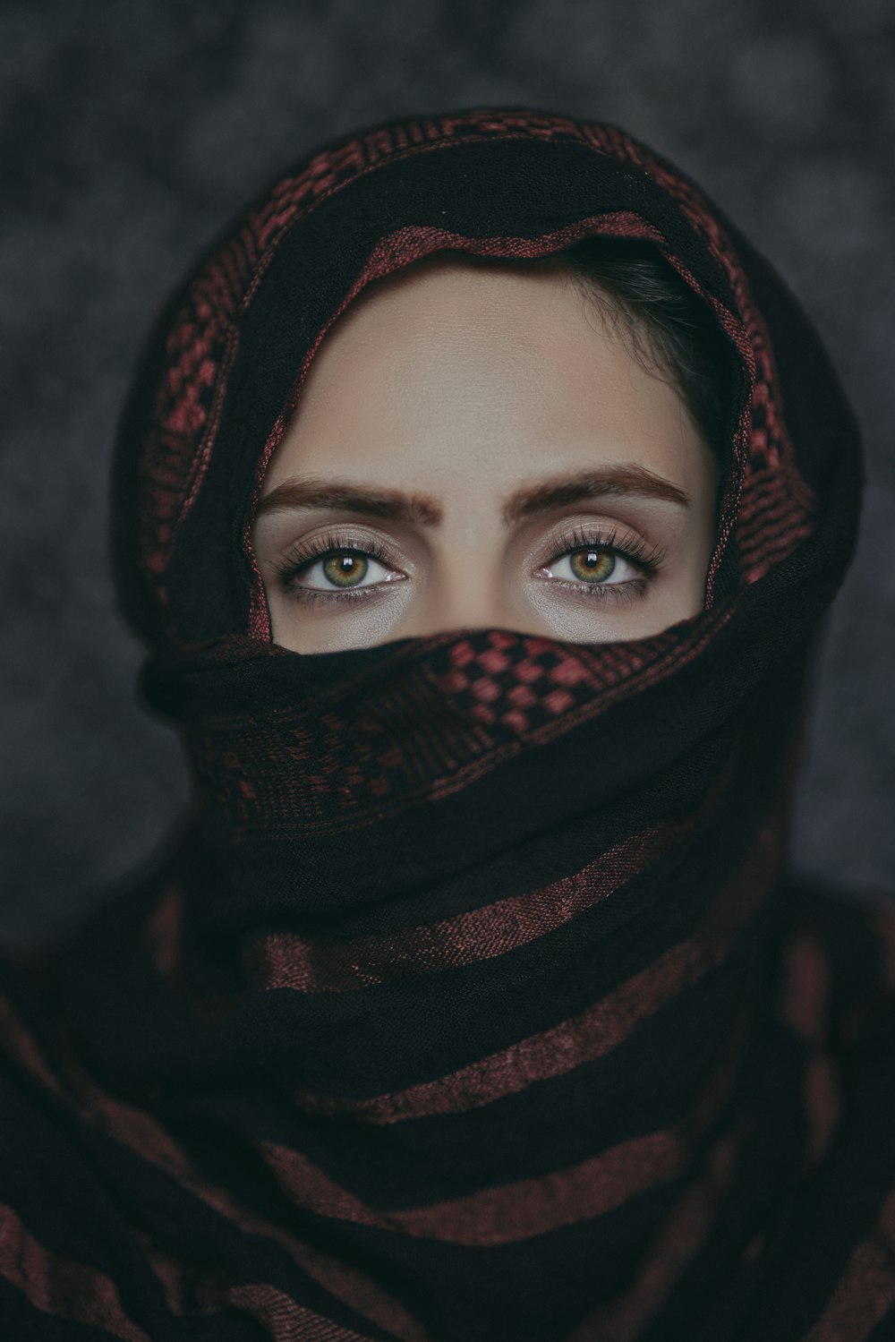 a woman wearing a black and red scarf