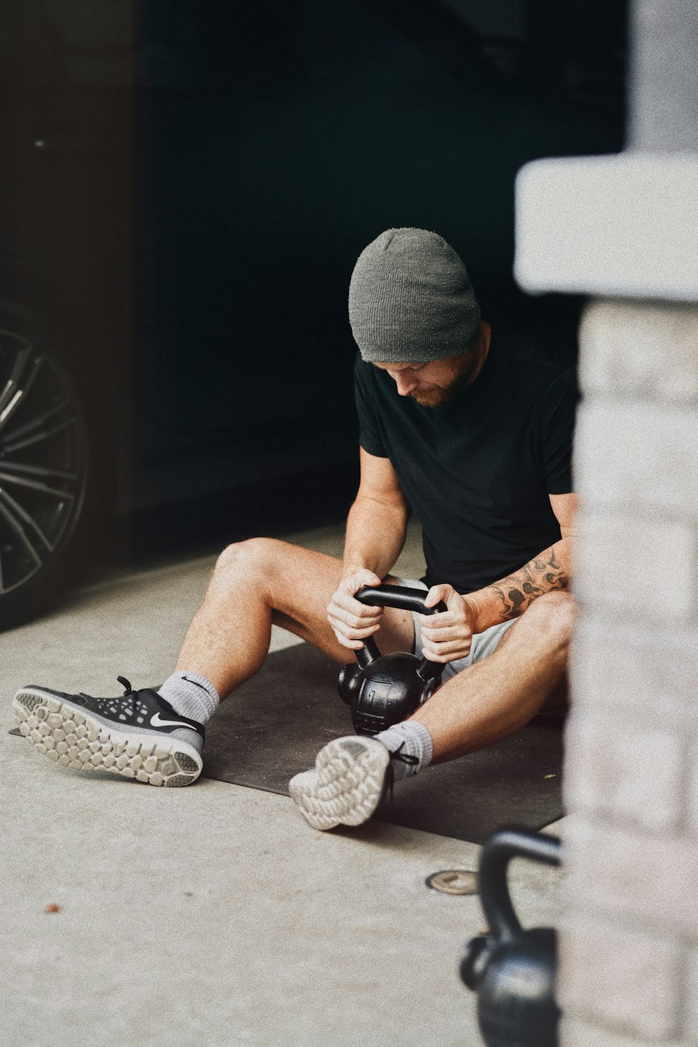 a man sitting on the ground with a skateboard