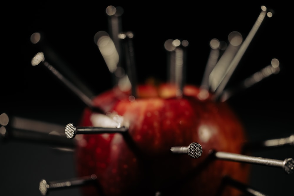 a bunch of screws sticking out of an apple