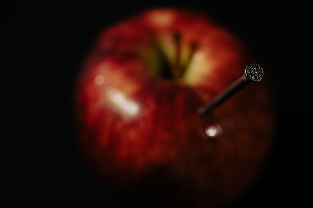 a close up of a red apple with a black background