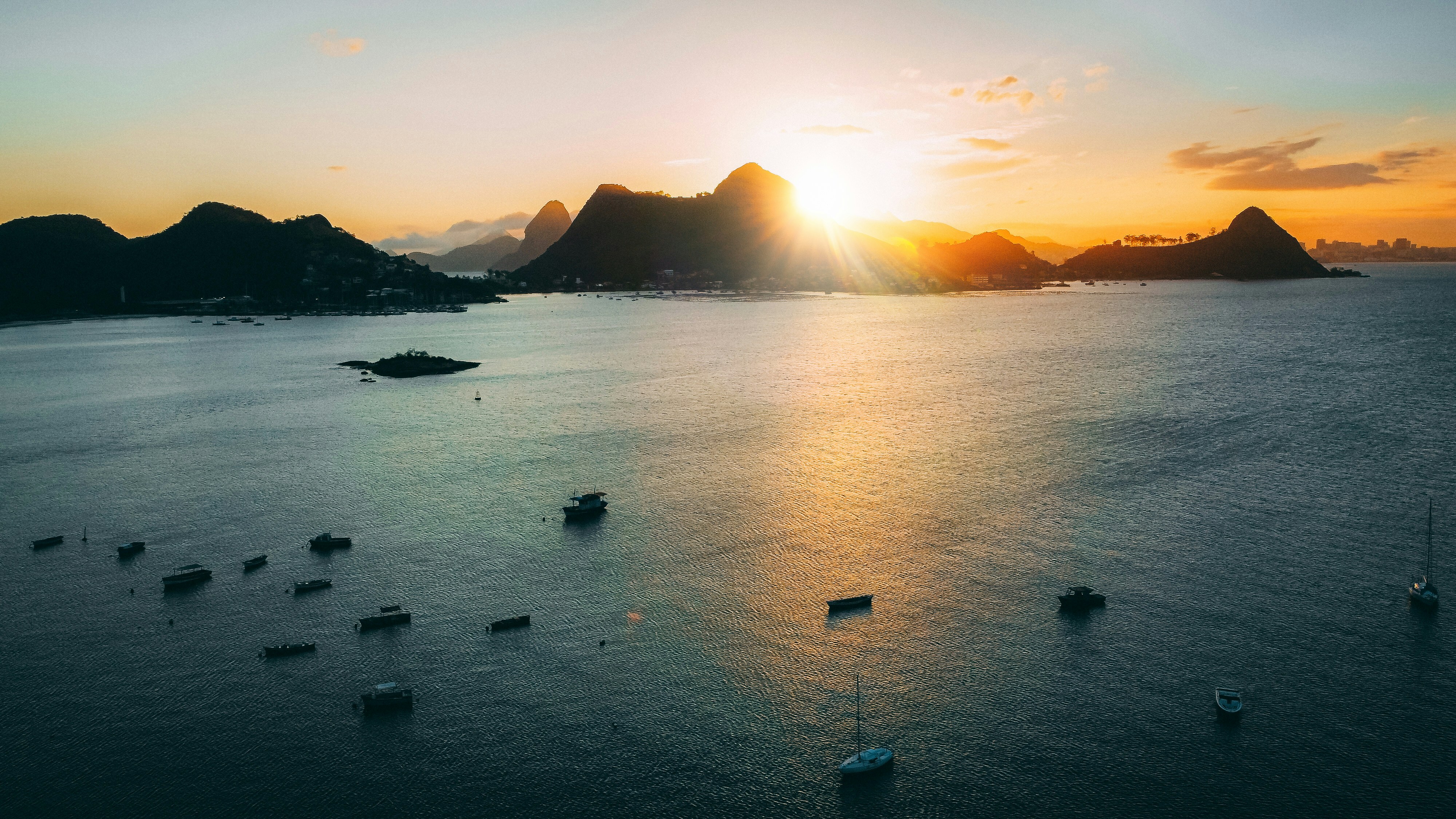 a group of boats floating on top of a large body of water