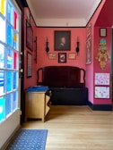 Cozy interior corner filled with colorful artwork and comfortable seating.