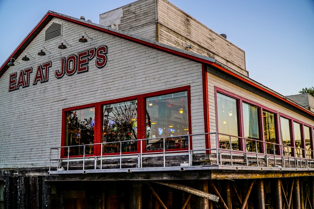 a red and white building with a sign that says eat at joe's