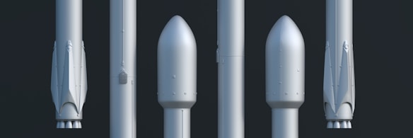 A lineup of five rocket components is displayed vertically against a dark background. Each component shows different stages or sections of a rocket, including what appear to be nose cones and booster stages. The components have a sleek, metallic surface with minimalistic detailing.