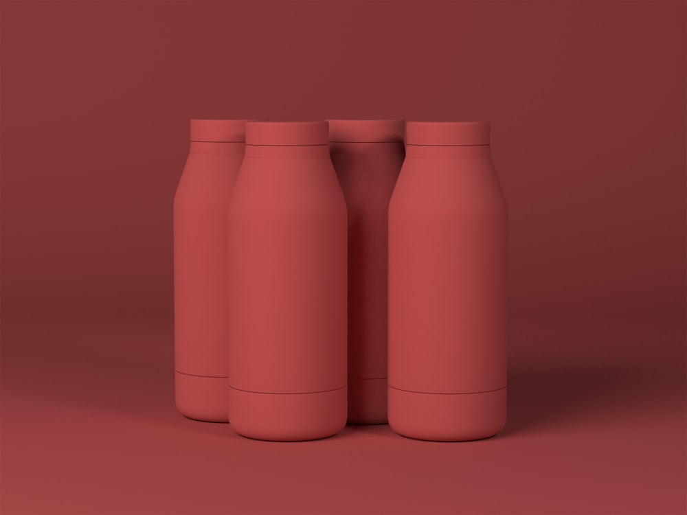 three red bottles on a red background